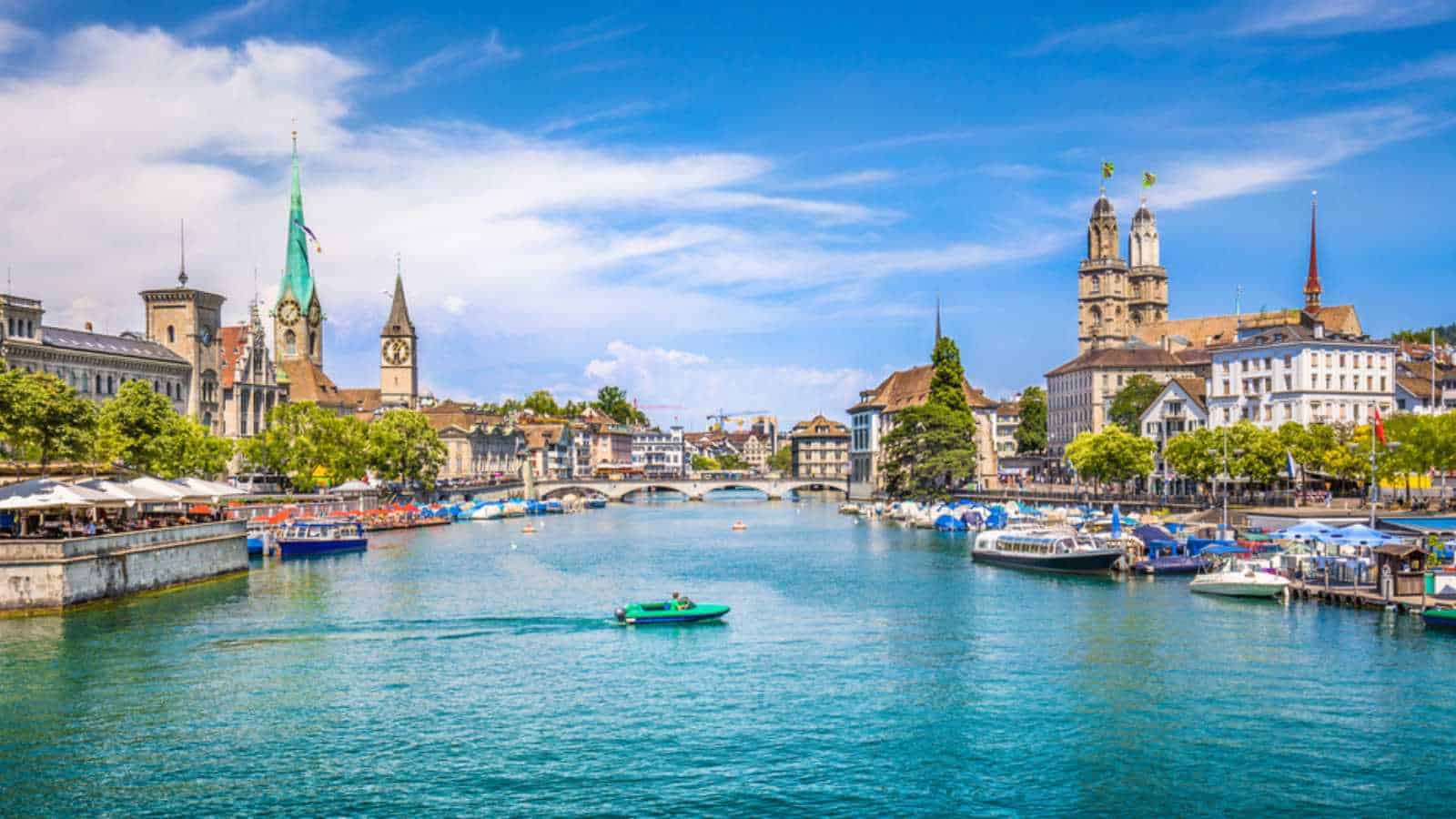 Panoramic view of historic Zurich city center with famous Fraumunster and Grossmunster Churches and river Limmat at Lake Zurich on a sunny day with clouds in summer, Canton of Zurich, Switzerland
