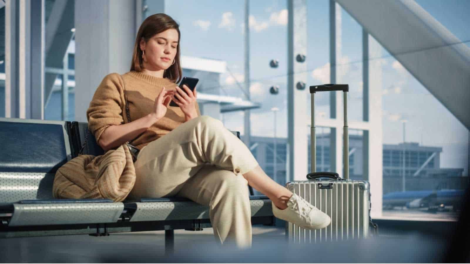 Woman checking mobile at airport