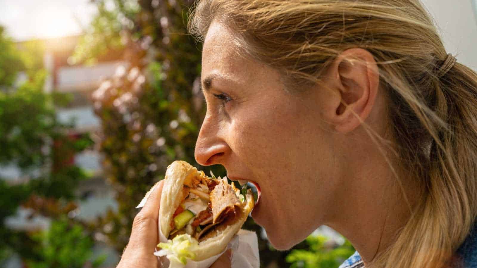 Woman eating sandwich