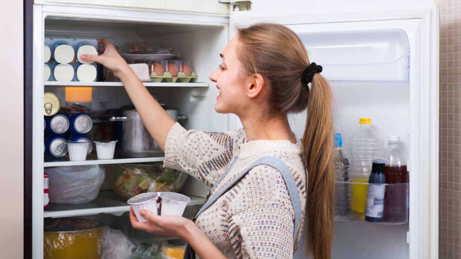 Woman using fridge