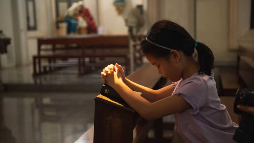 Child praying in church