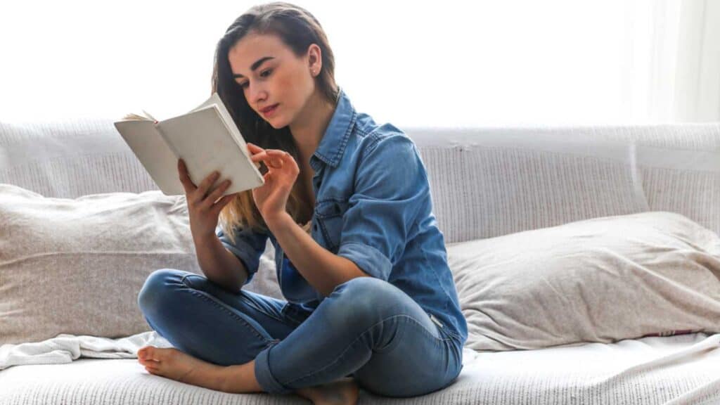 Woman reading book on bed