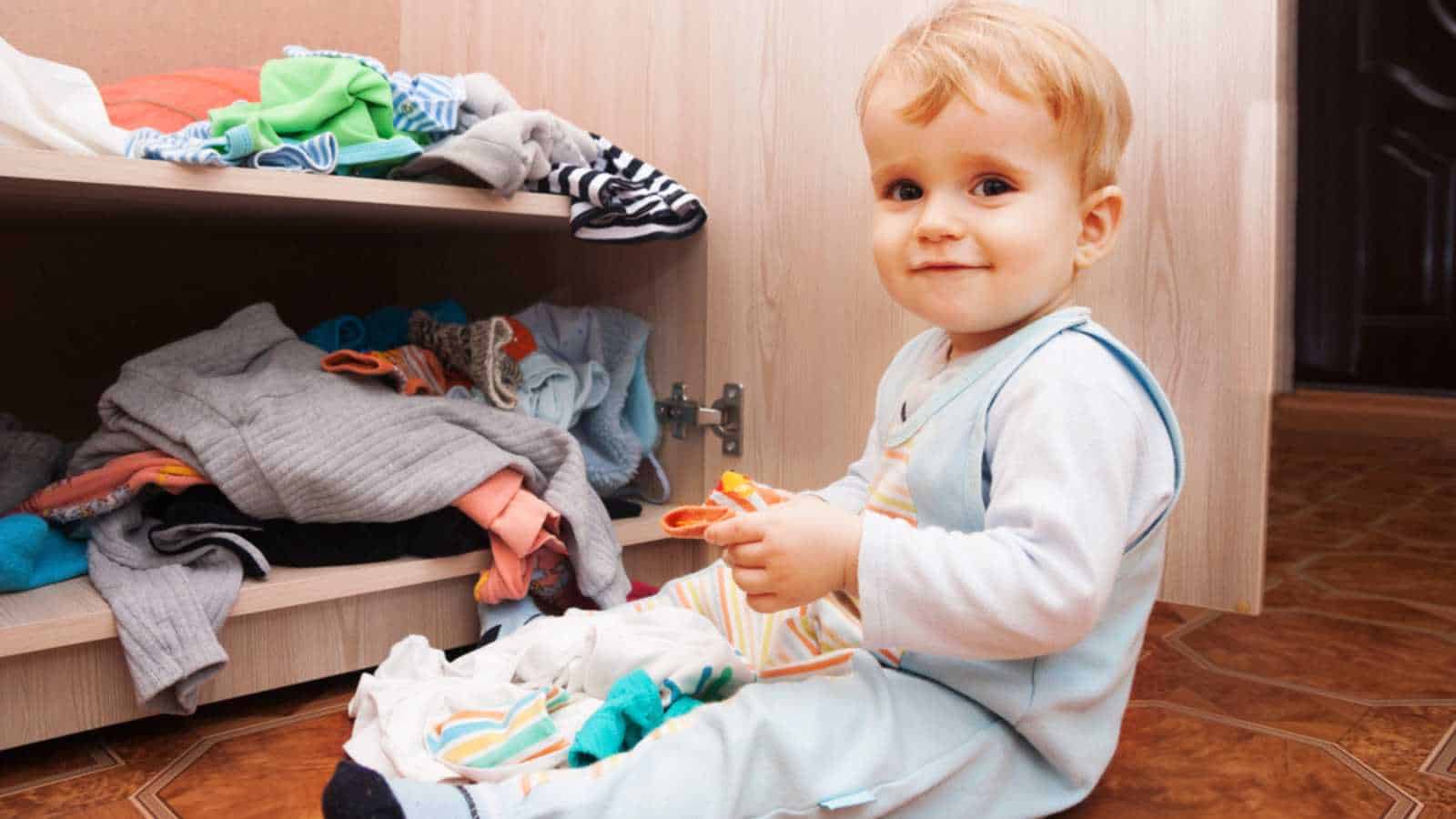 Baby playing in cupboard