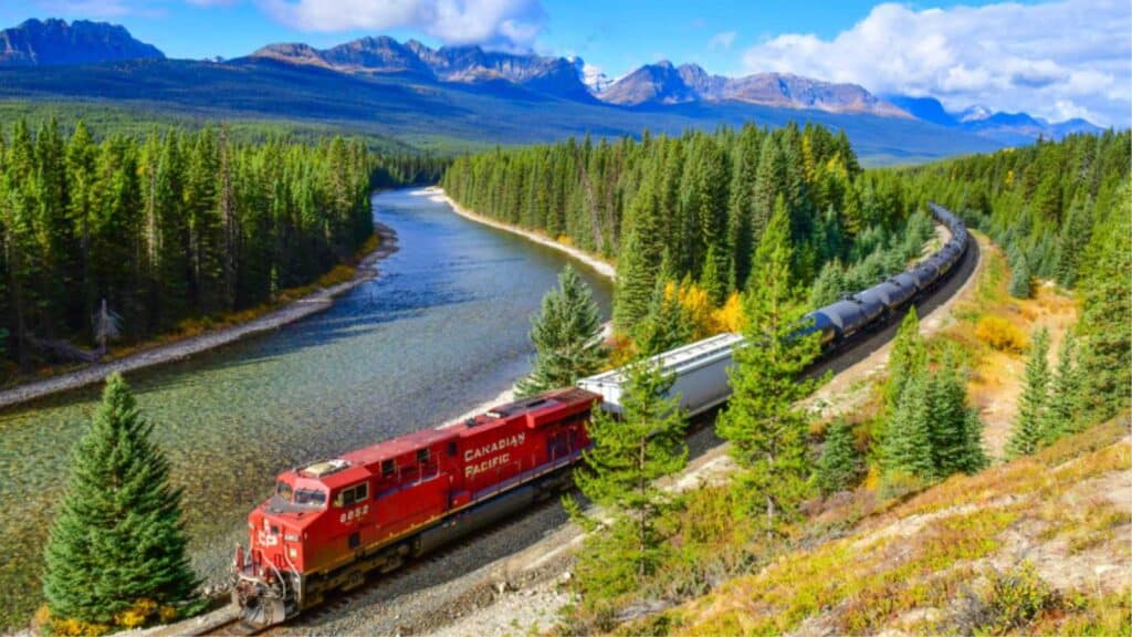 ALBERTA, CANADA - October 1,2017: Long freight train Canadian Pacific Railway (CPR) moving along Bow river in Canadian Rockies ,Banff National Park, Canadian Rockies,Canada.