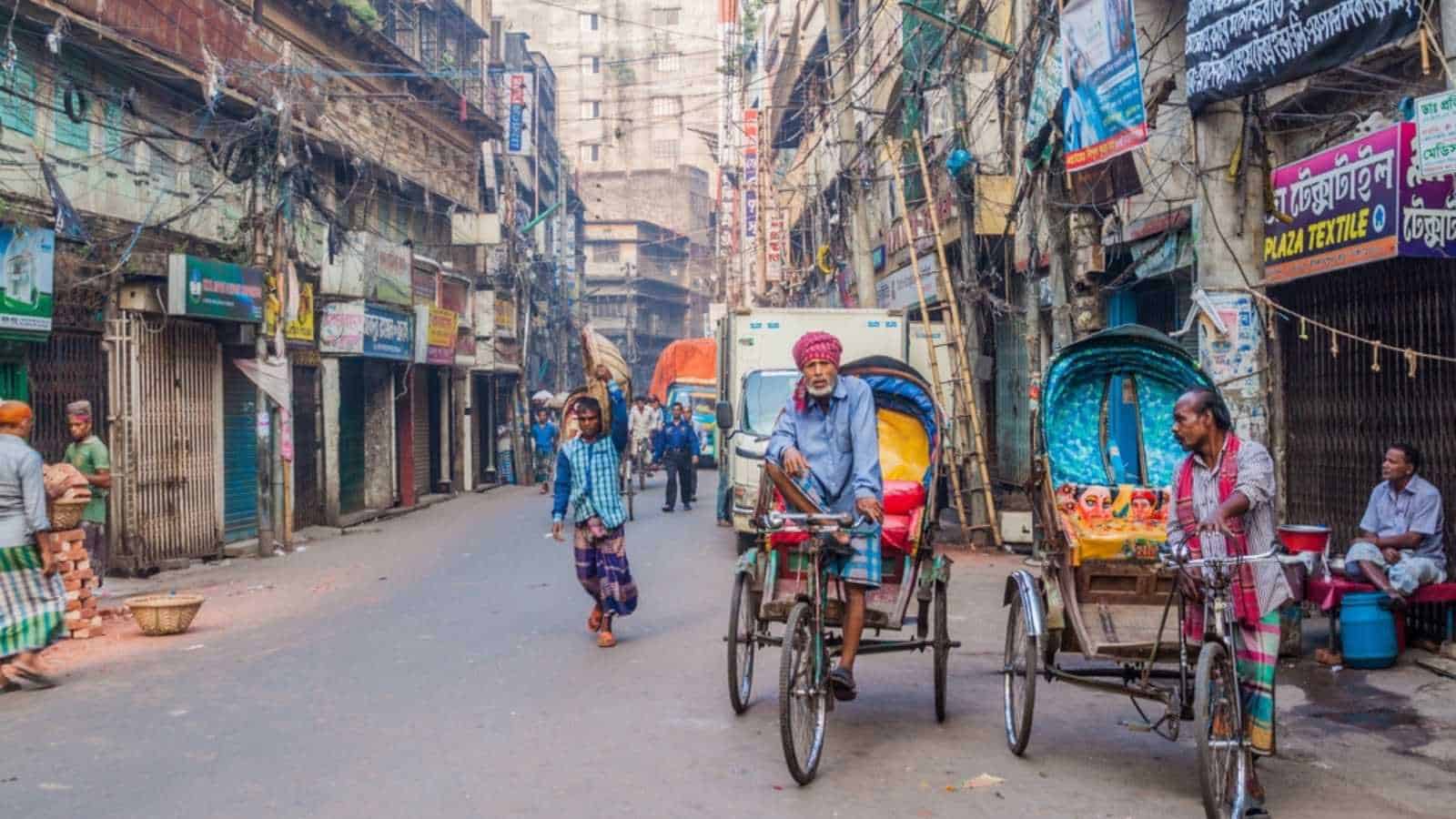 DHAKA, BANGLADESH - NOVEMBER 20, 2016: Cyclo rickshaw drivers in Old Dhaka, Bangladesh.