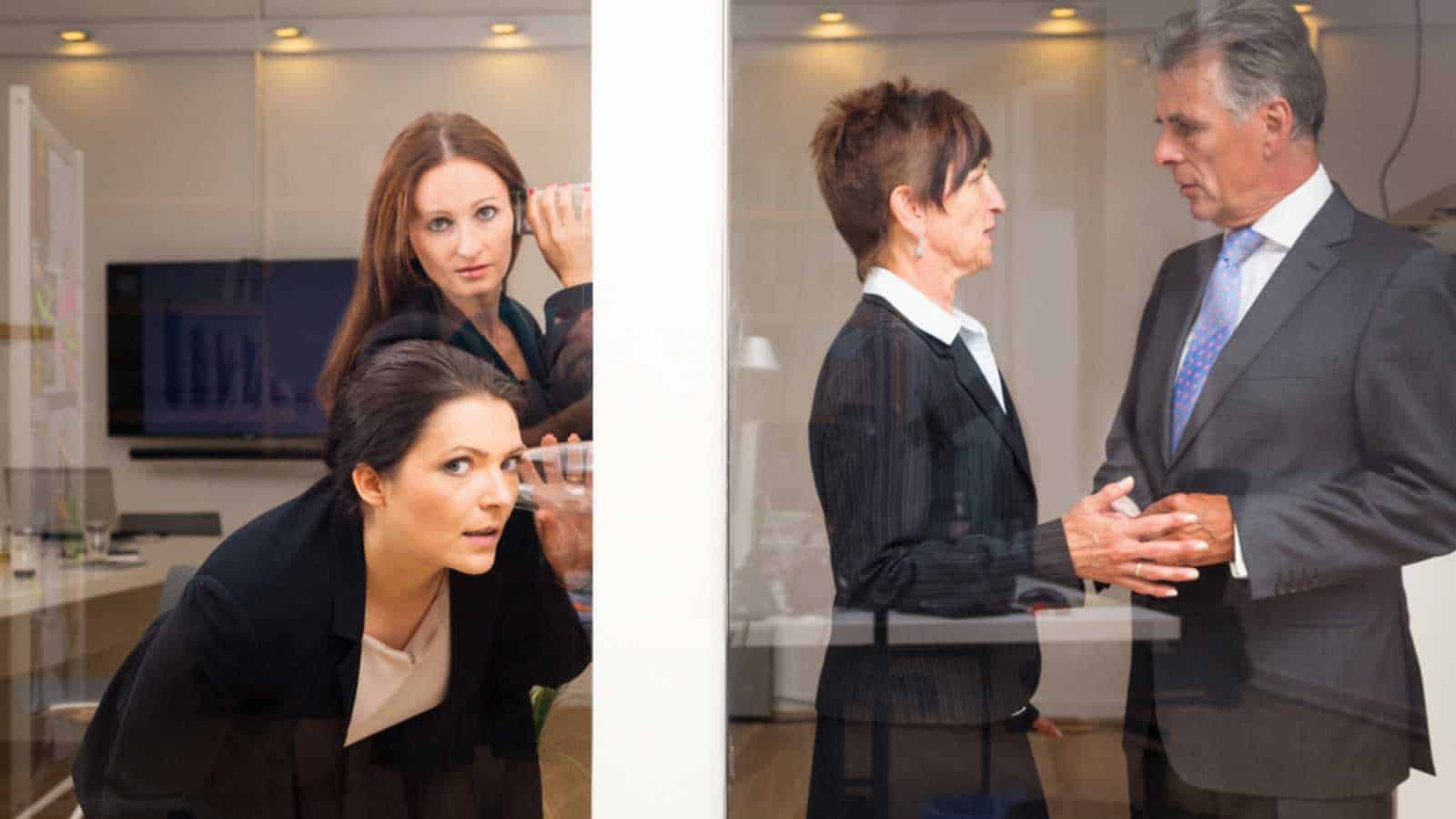 Businesswomen Eavesdropping On Their Superiors