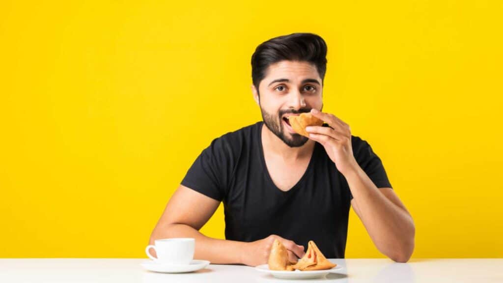 Man eating samosa