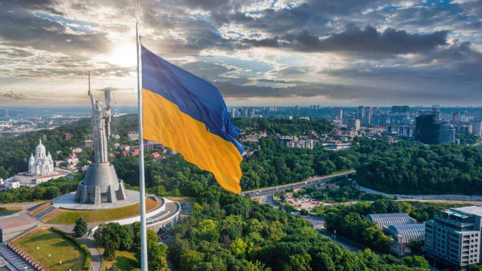 Kyiv, Ukraine. July 10, 2021. Aerial view of the Ukrainian flag waving in the wind against the city of Kyiv, Ukraine near the famous statue of Motherland.