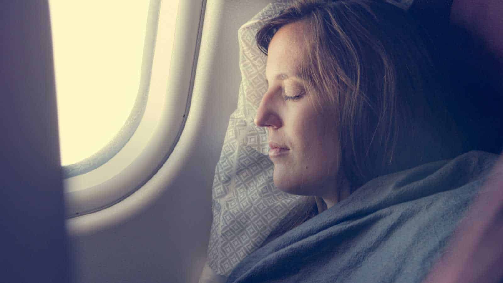 Sleeping in flight covered with blanket