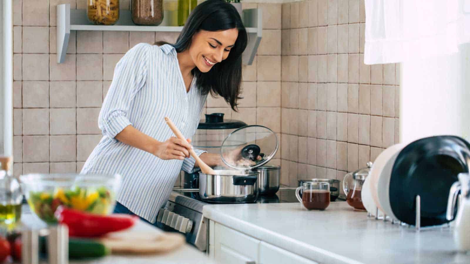 Woman cooking in stainless steel pan