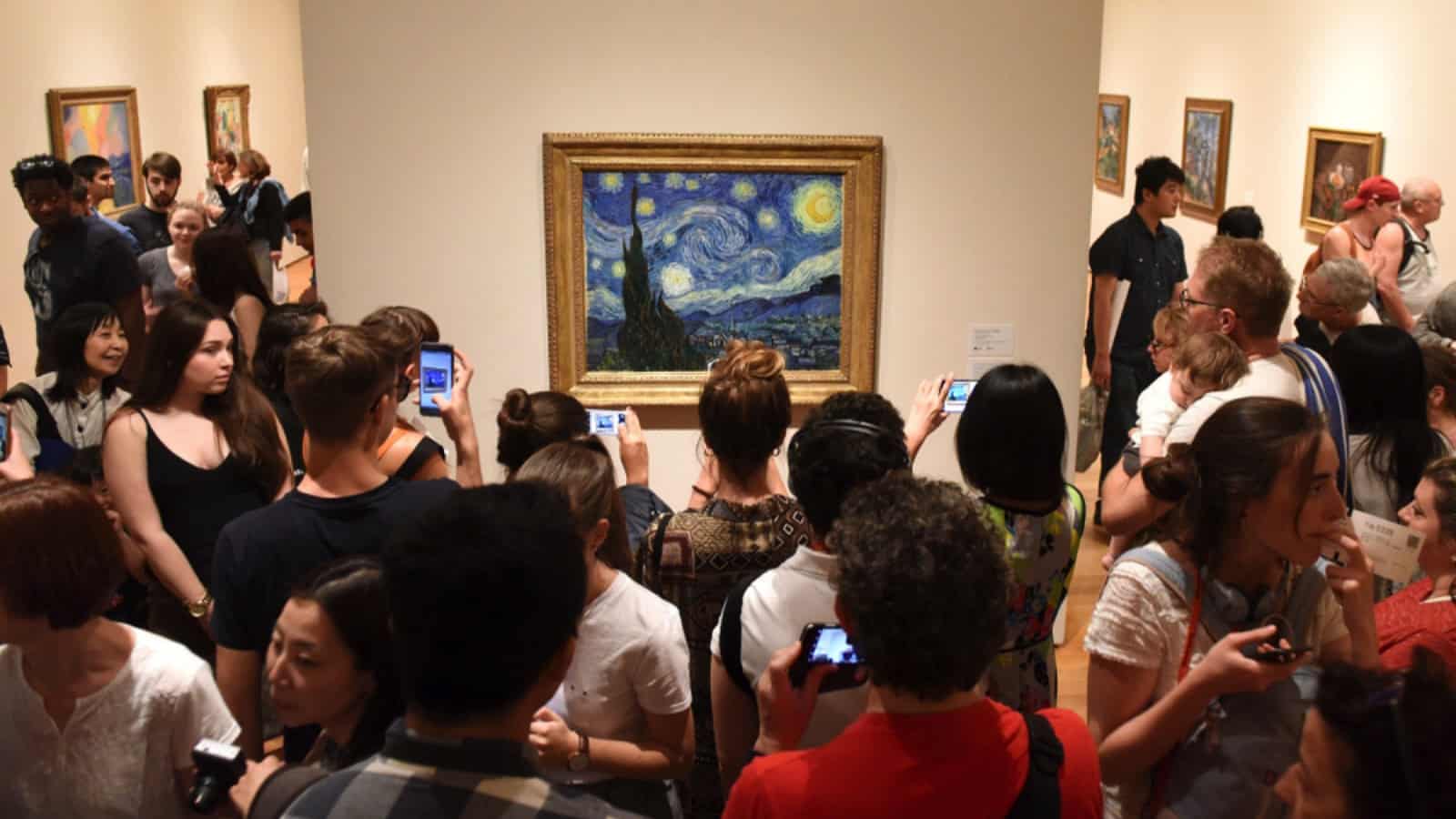 Crowd looking at Vincent Van Gogh painting