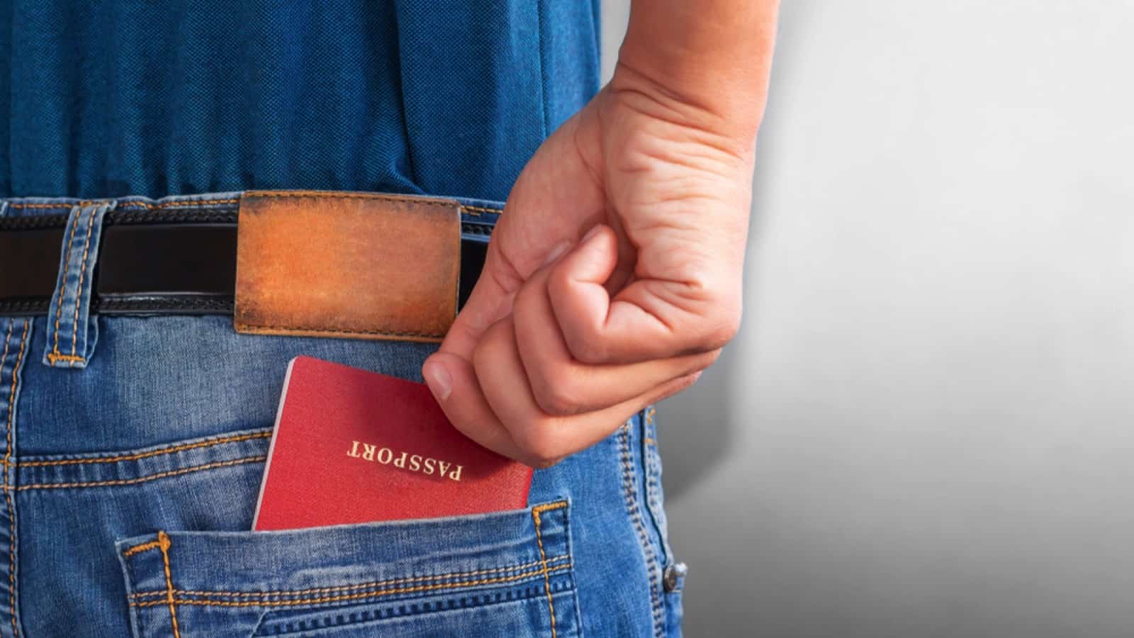 Man taking passport out of back pocket