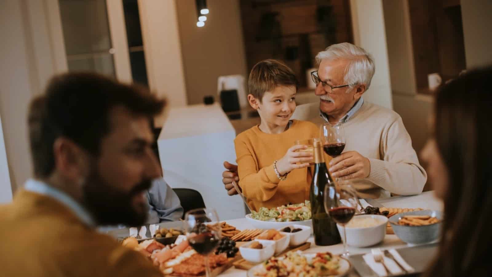 Old man having dinner with family
