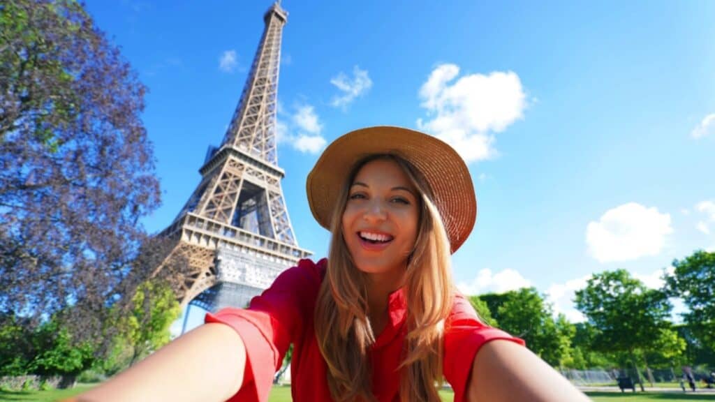 Woman taking selfie infront of Eiffel Tower, Paris