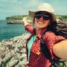 Woman traveler taking selfie near beach