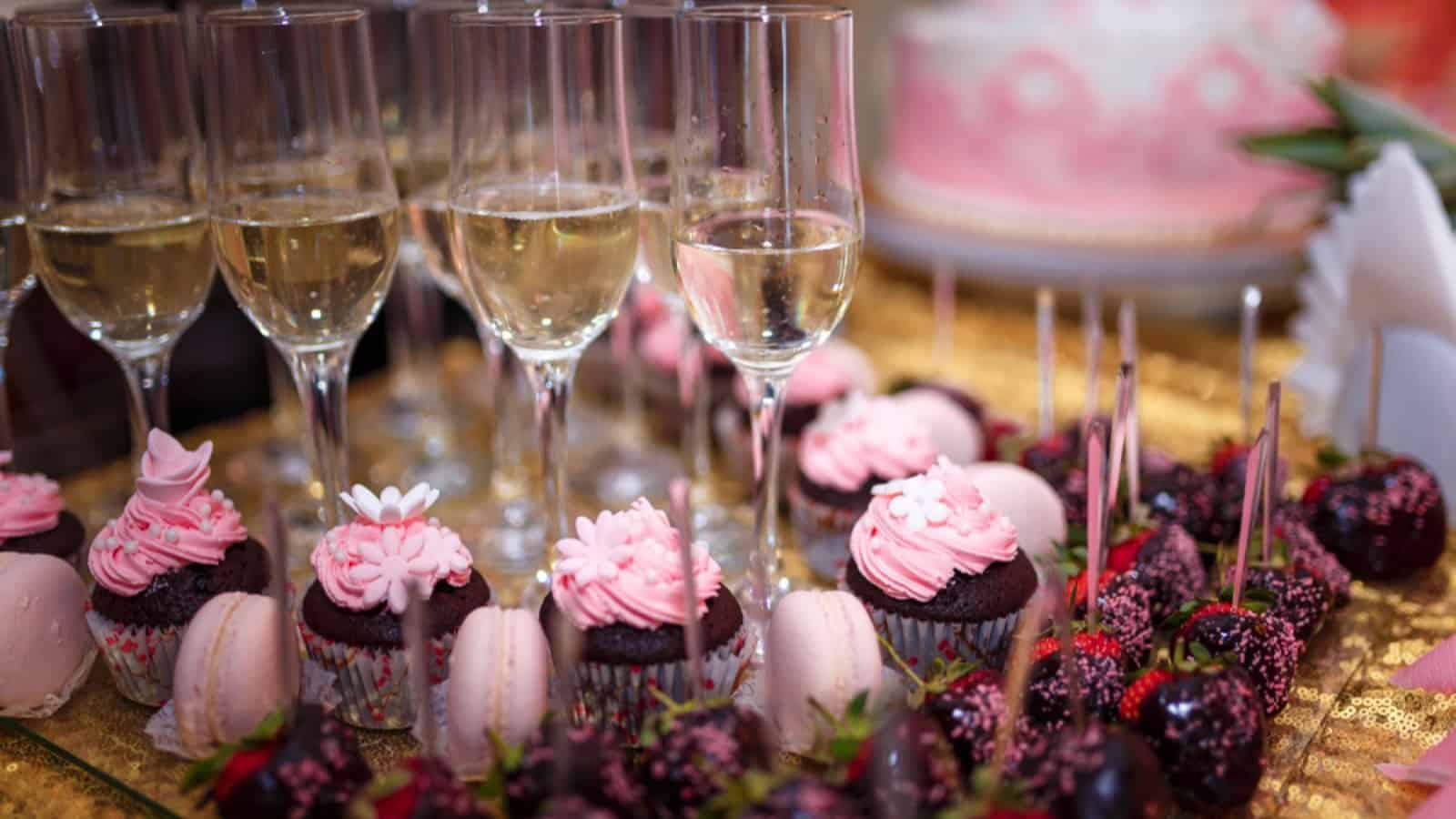 Cupcakes and champagne glasses on table