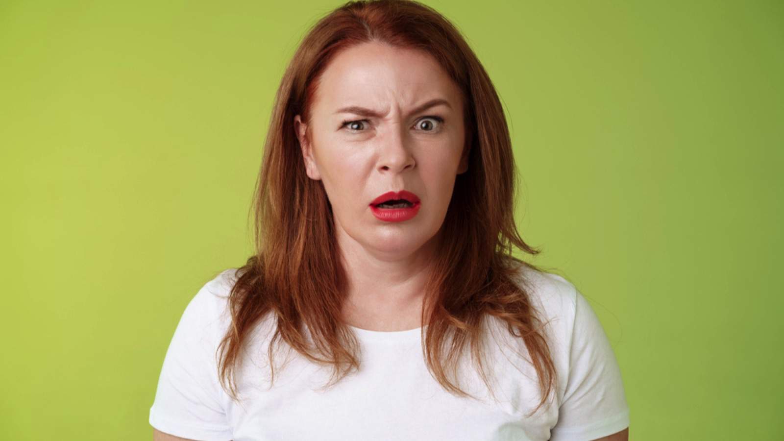 Confused shocked gasping middle-aged woman