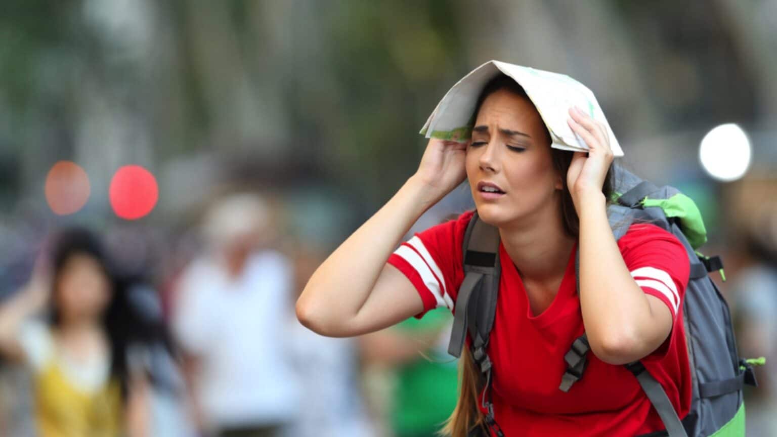 A frustrated traveler reviewing a travel itinerary with mistakes highlighted