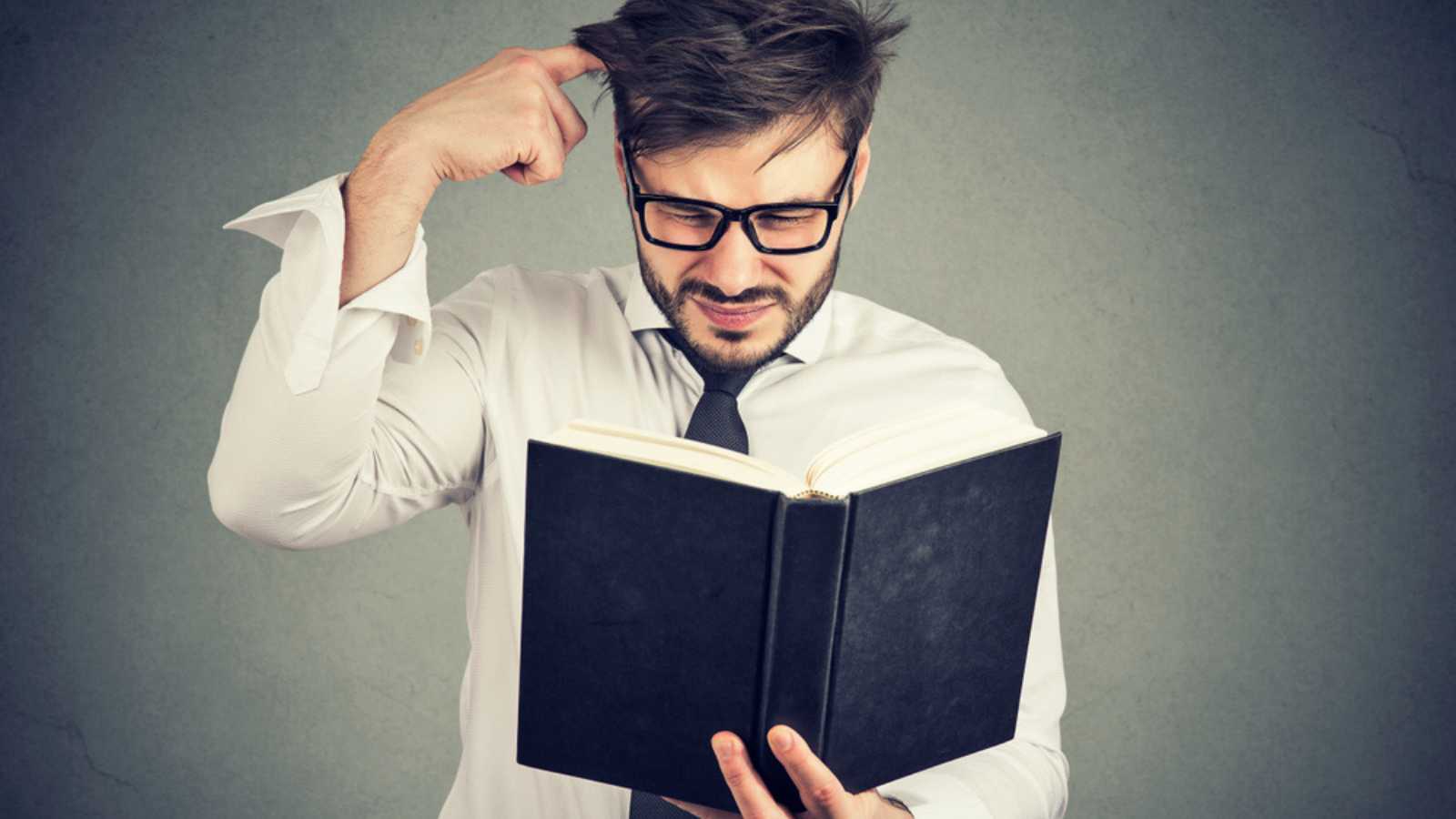 Man confused with book