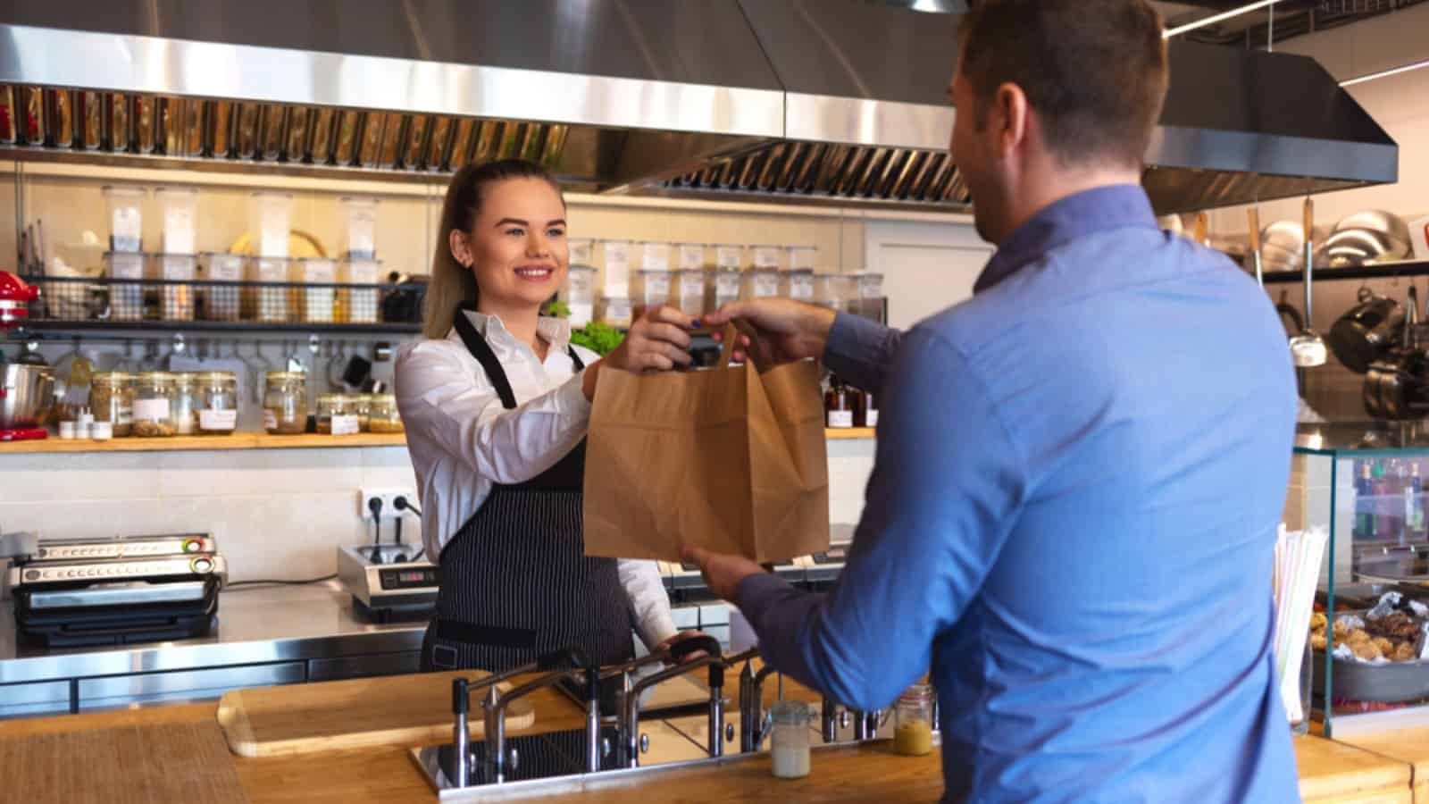 Man getting parcel from restaurant