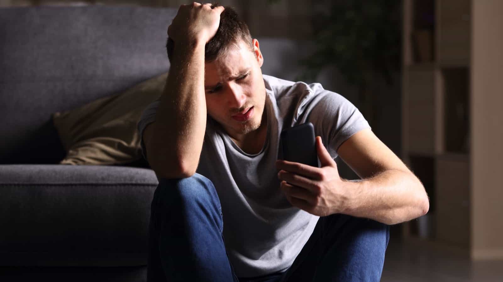 Stressed man using mobile