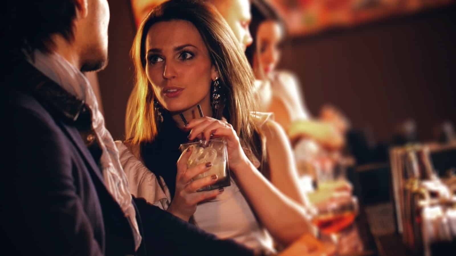 Woman drinking wine in Bar