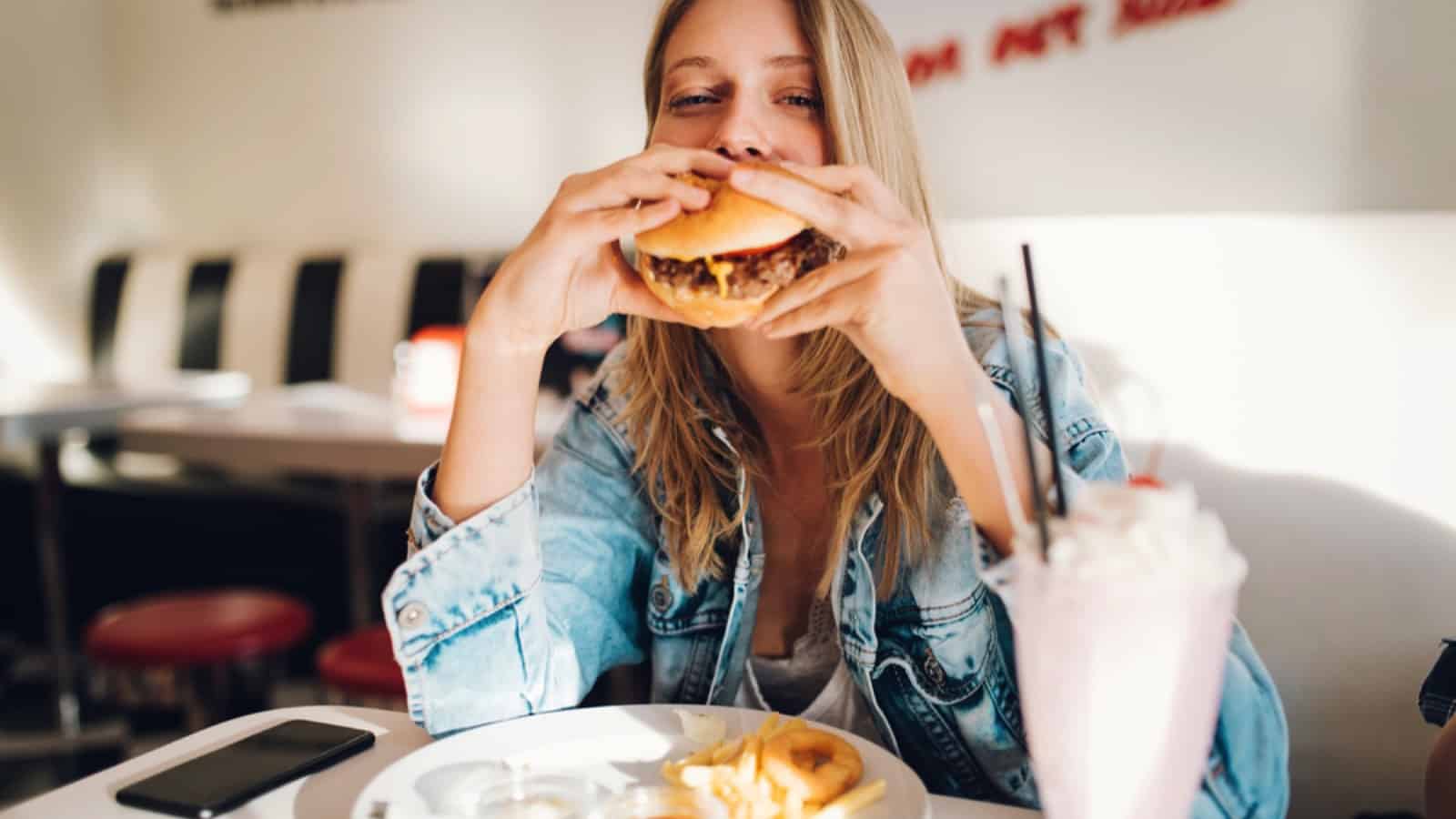 Woman eating cheese burger