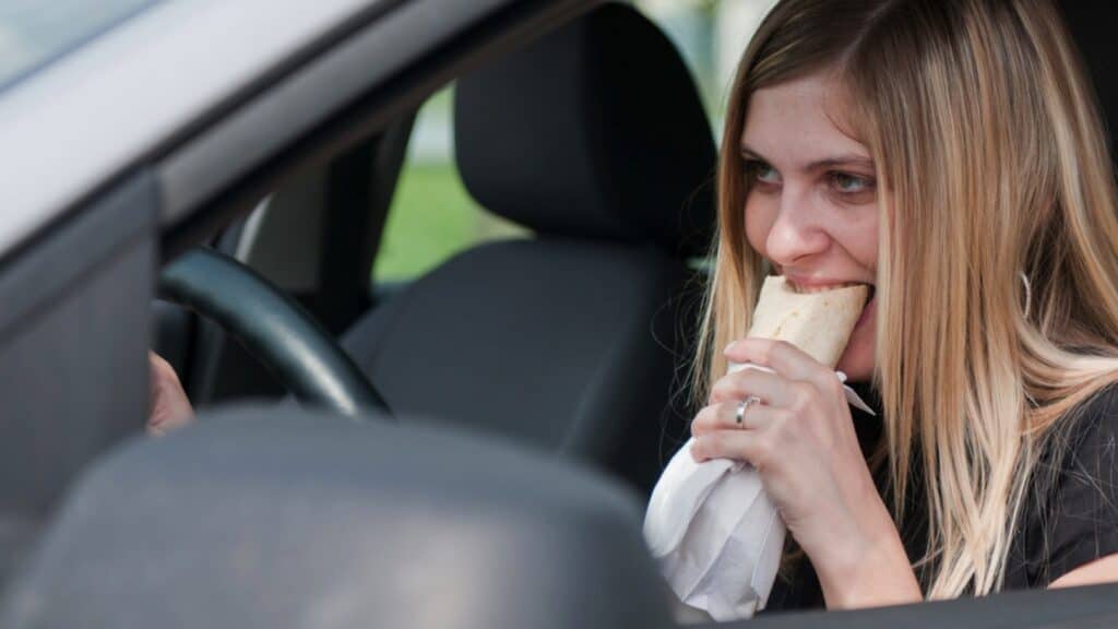 Woman eating in car