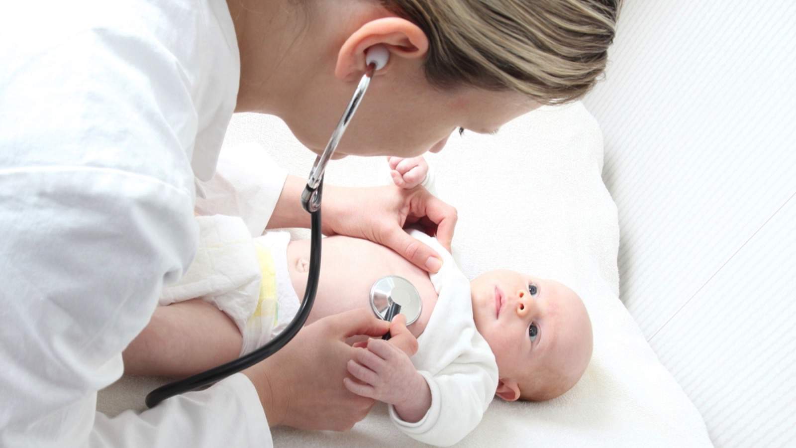 Pediatrician checking newborn