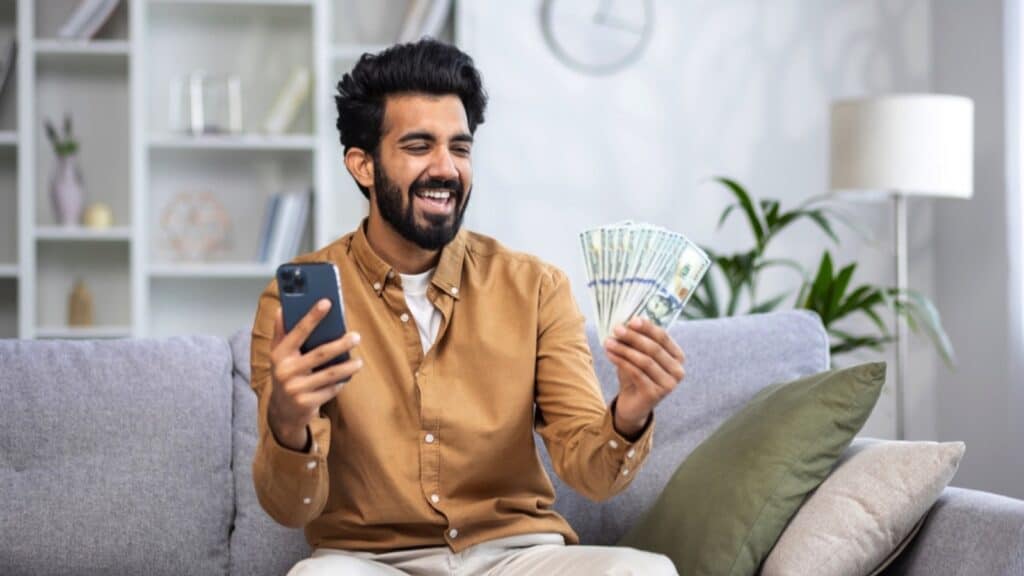 Man with mobile and money